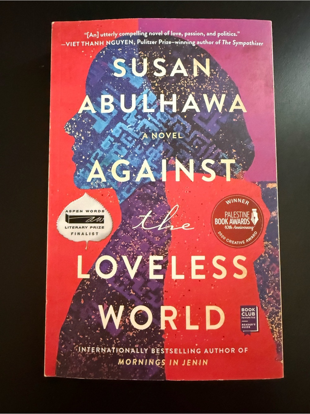 Against the Loveless World by Susan Abulhawa — Red & Blue Paperback Novel
